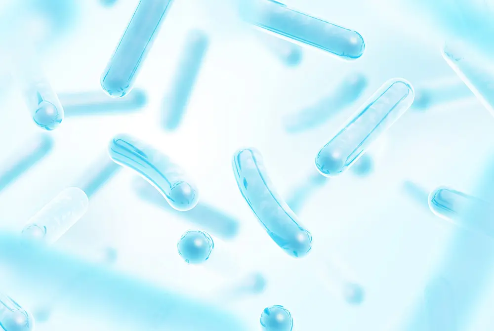 青色で表現された細菌のイラスト。口腔内の細菌や微生物を示すイメージ。