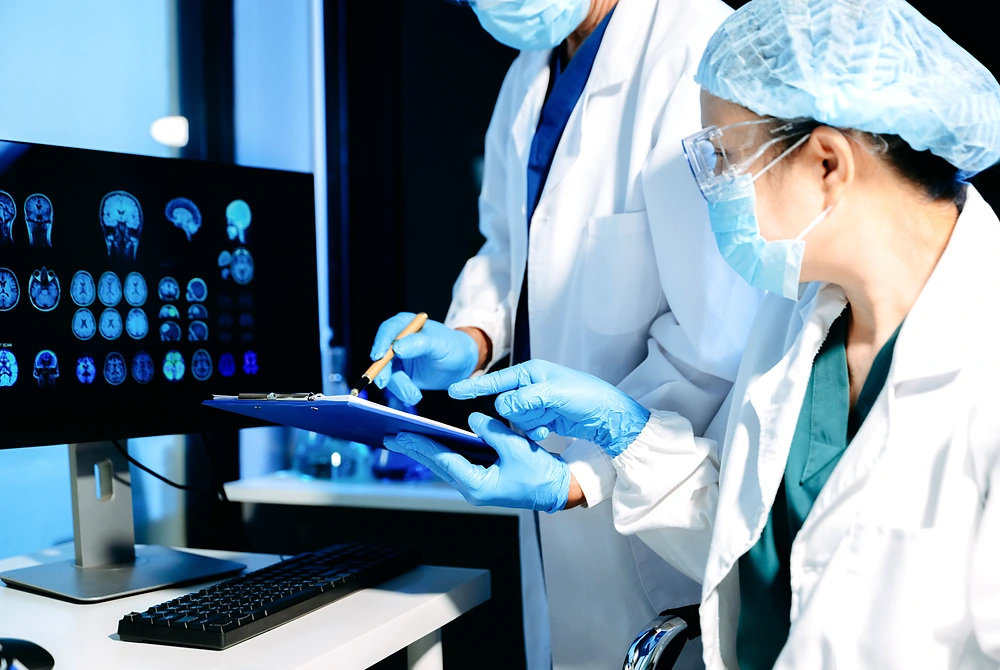 医師らが脳画像の表示されたモニターを見ながら診断内容を確認している様子。
